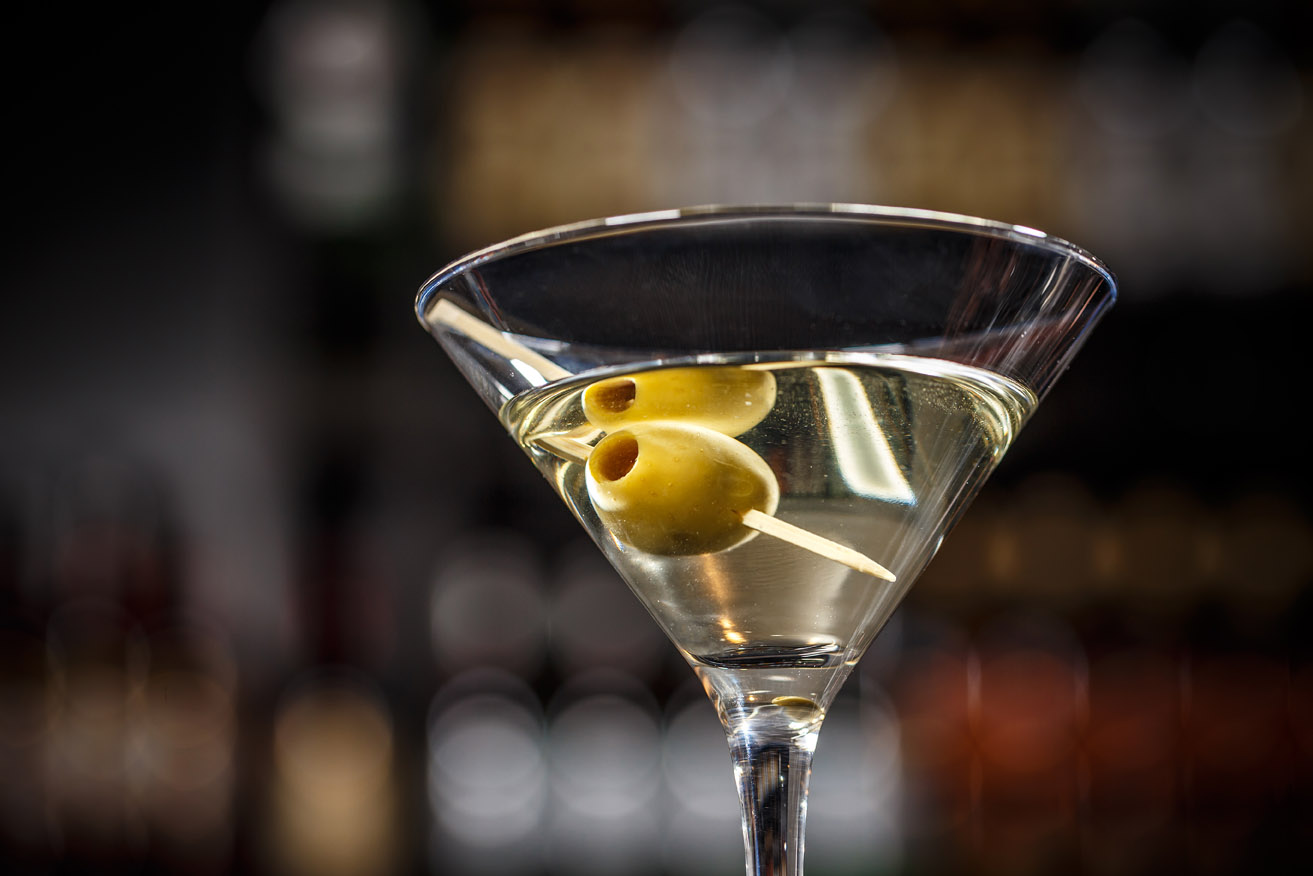 Close up of martini cocktail with green olives